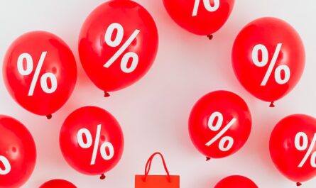 A Red Paper Bag in the Middle of Red Balloons With Percentage Symbols