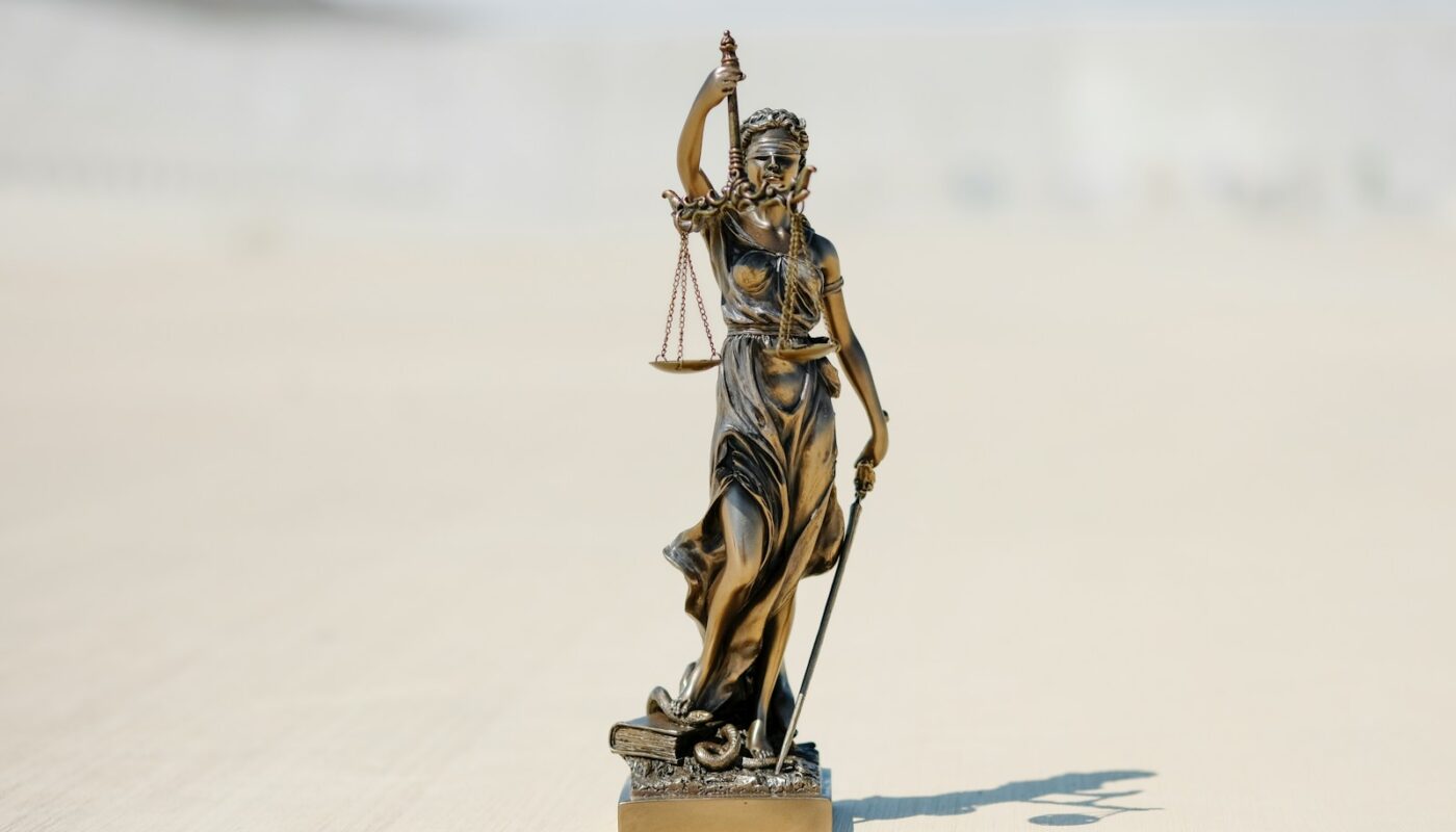 a statue of a person holding a staff