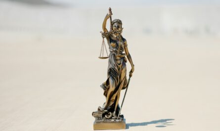 a statue of a person holding a staff