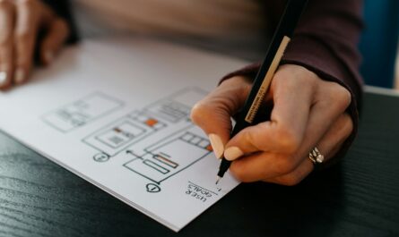 person writing on white paper